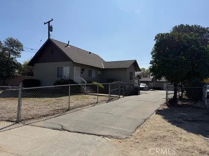 a couple of cars parked in front of a house