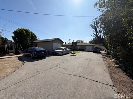 a front view of a house with a yard and sitting area