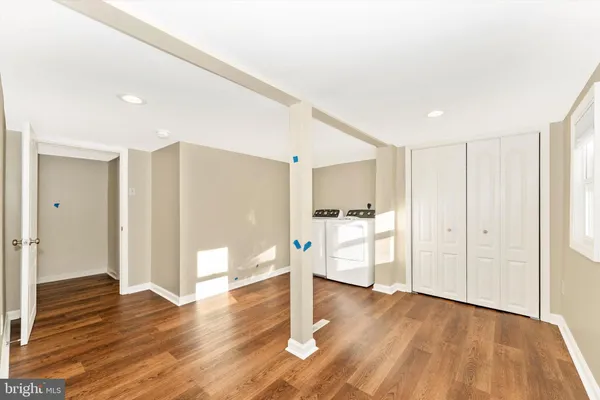 a view of a room with wooden floor