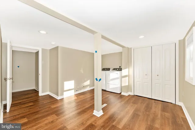a view of a room with wooden floor