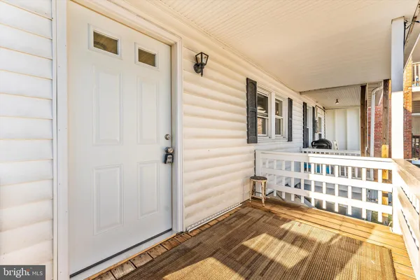 a view of a bedroom with wooden floor and a window