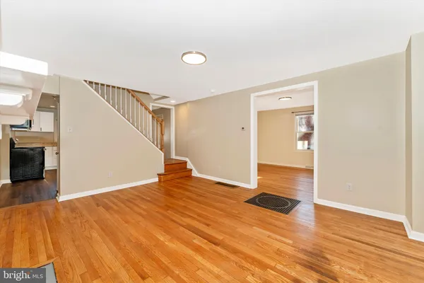 a view of an empty room with wooden floor