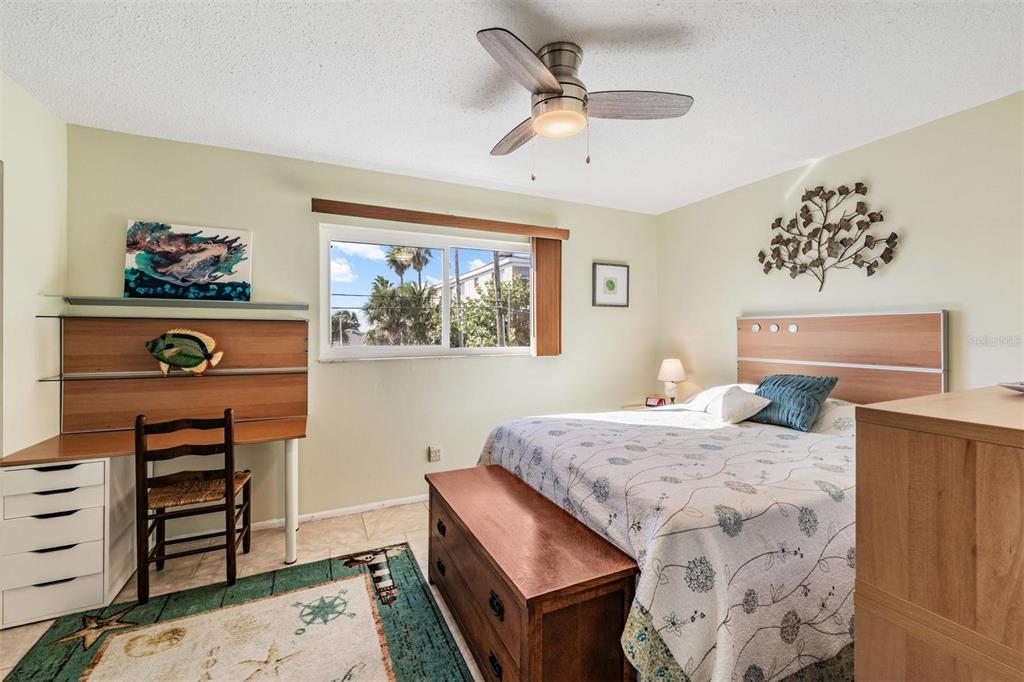 2110 Gulf Boulevard, Unit 8 Indian Rocks Beach, FL 33785 - Photo 20 of 34 a bedroom with a bed and a dresser