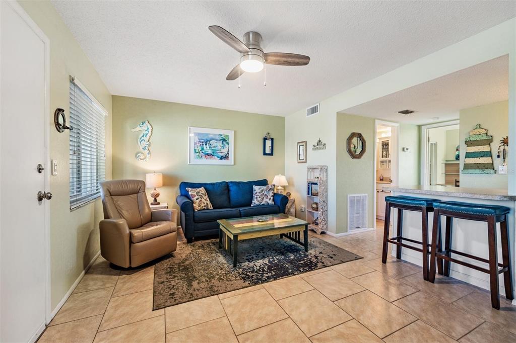 2110 Gulf Boulevard, Unit 8 Indian Rocks Beach, FL 33785 - Photo 6 of 34 a living room with furniture and wooden floor