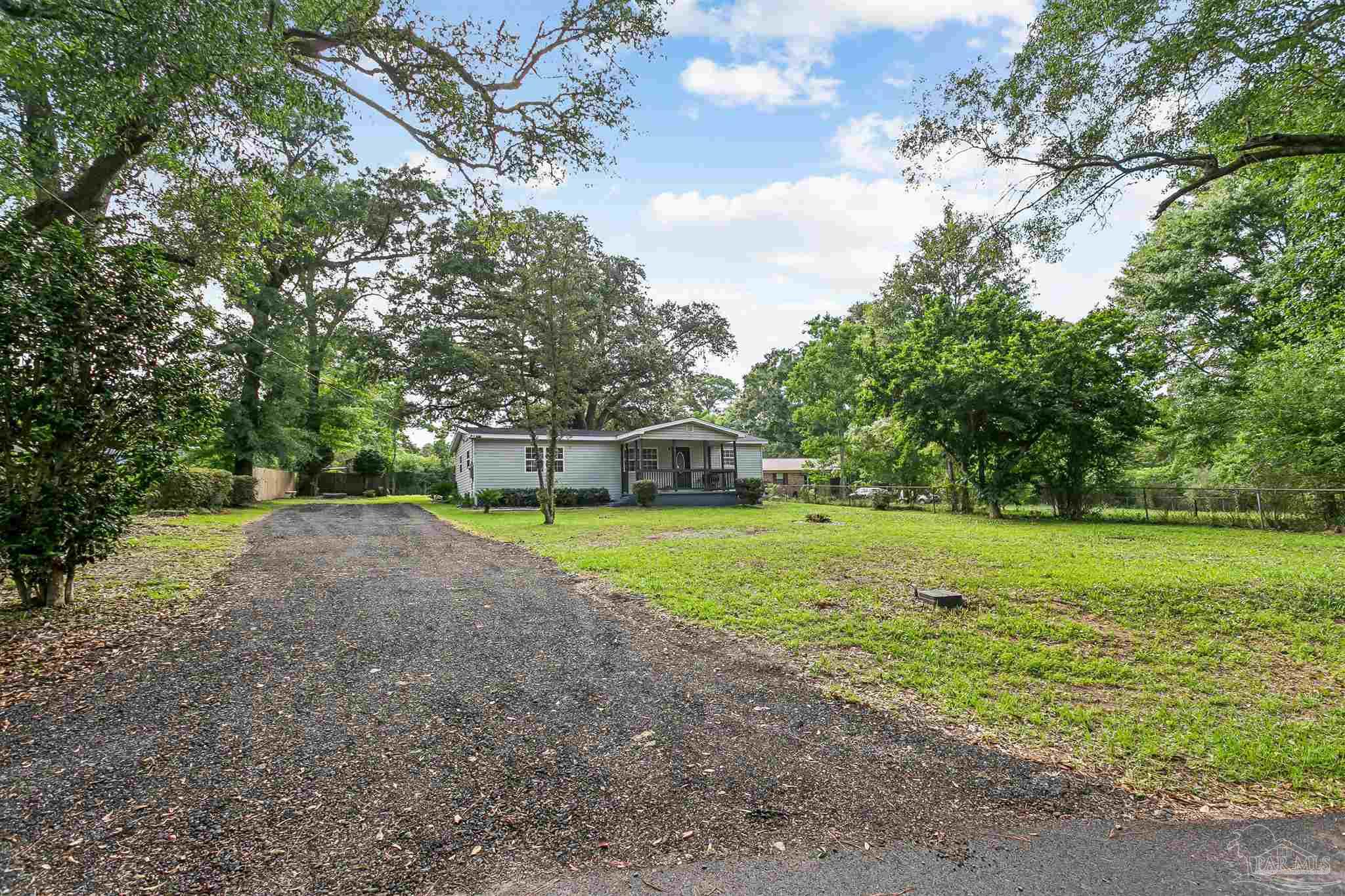1095 River Annex Road Cantonment, FL 32533 - Photo 2 of 32 a green field with lots of trees
