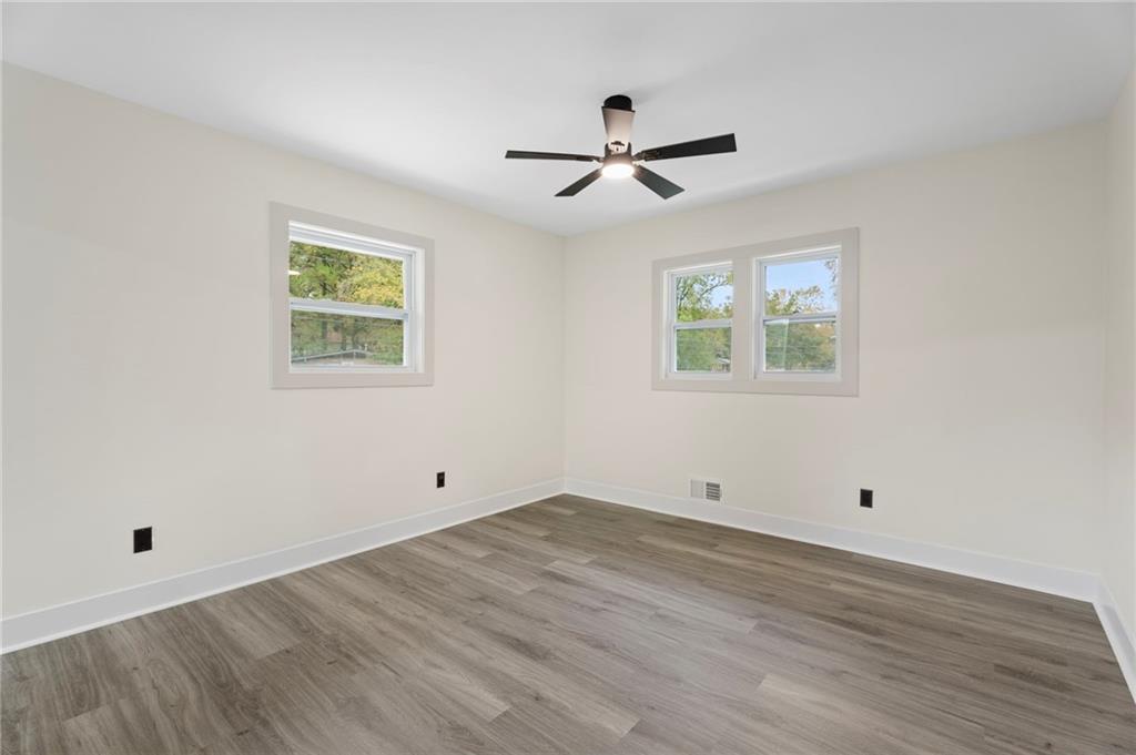 3991 Lindsey Drive Decatur, GA 30035 - Photo 11 of 29 a view of empty room with wooden floor and fan