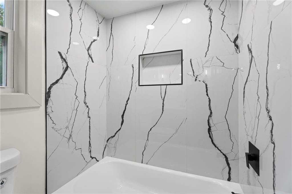 3991 Lindsey Drive Decatur, GA 30035 - Photo 20 of 29 a bathroom with a bathtub and a shower