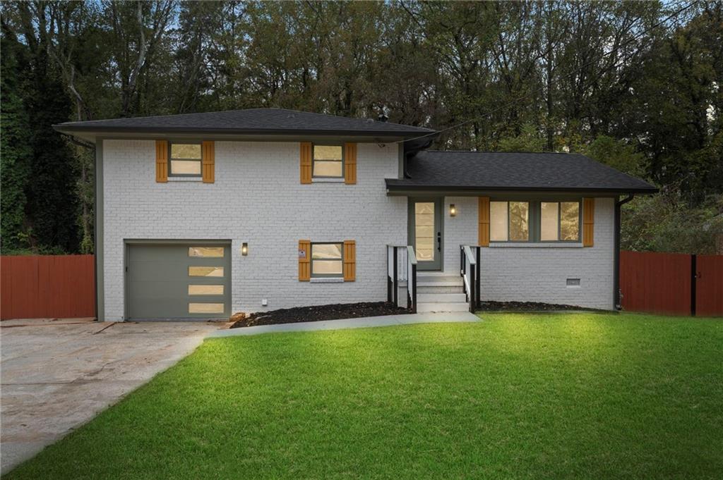 3991 Lindsey Drive Decatur, GA 30035 - Photo 2 of 29 a front view of a house with a yard and garage