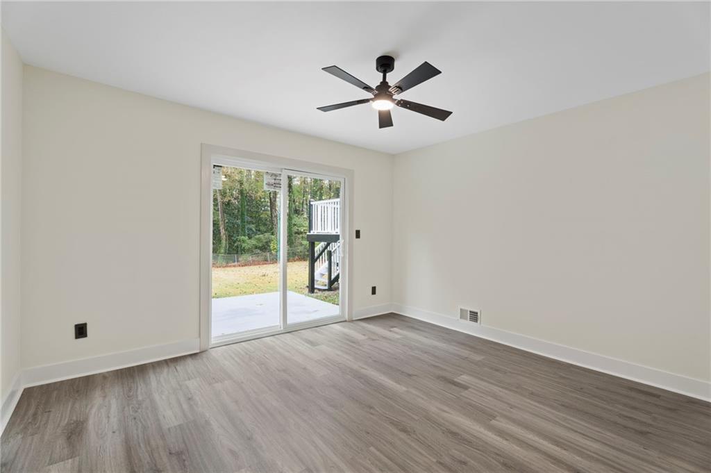 3991 Lindsey Drive Decatur, GA 30035 - Photo 23 of 29 a view of empty room with wooden floor and fan