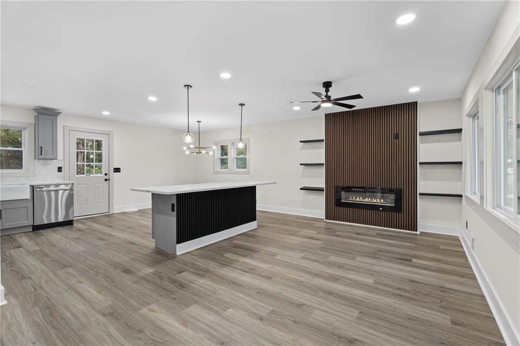 3991 Lindsey Drive Decatur, GA 30035 - Photo 7 of 29 a view of a kitchen with a sink a kitchen island a refrigerator wooden floor and a fireplace
