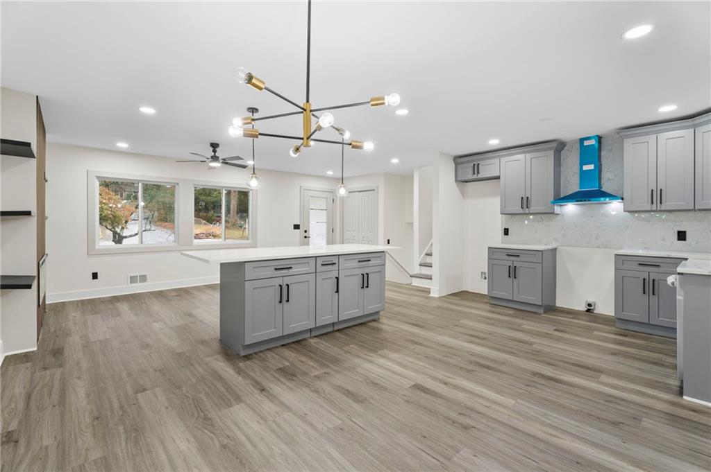3991 Lindsey Drive Decatur, GA 30035 - Photo 9 of 29 a large kitchen with stainless steel appliances kitchen island a large counter top and a wooden floors