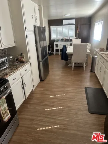 a living room with furniture a fireplace a flat screen tv and a table