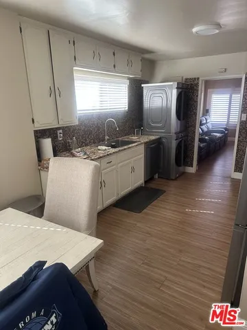 a kitchen with stainless steel appliances granite countertop a sink dishwasher stove refrigerator and cabinets