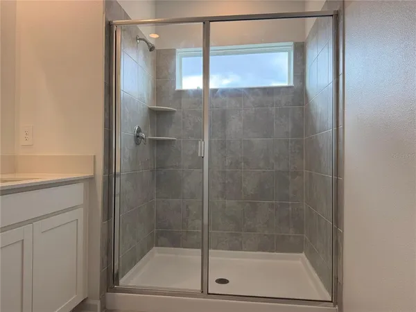 a bathroom with a glass shower door