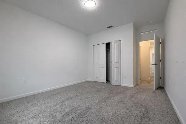 a view of an empty room and a window