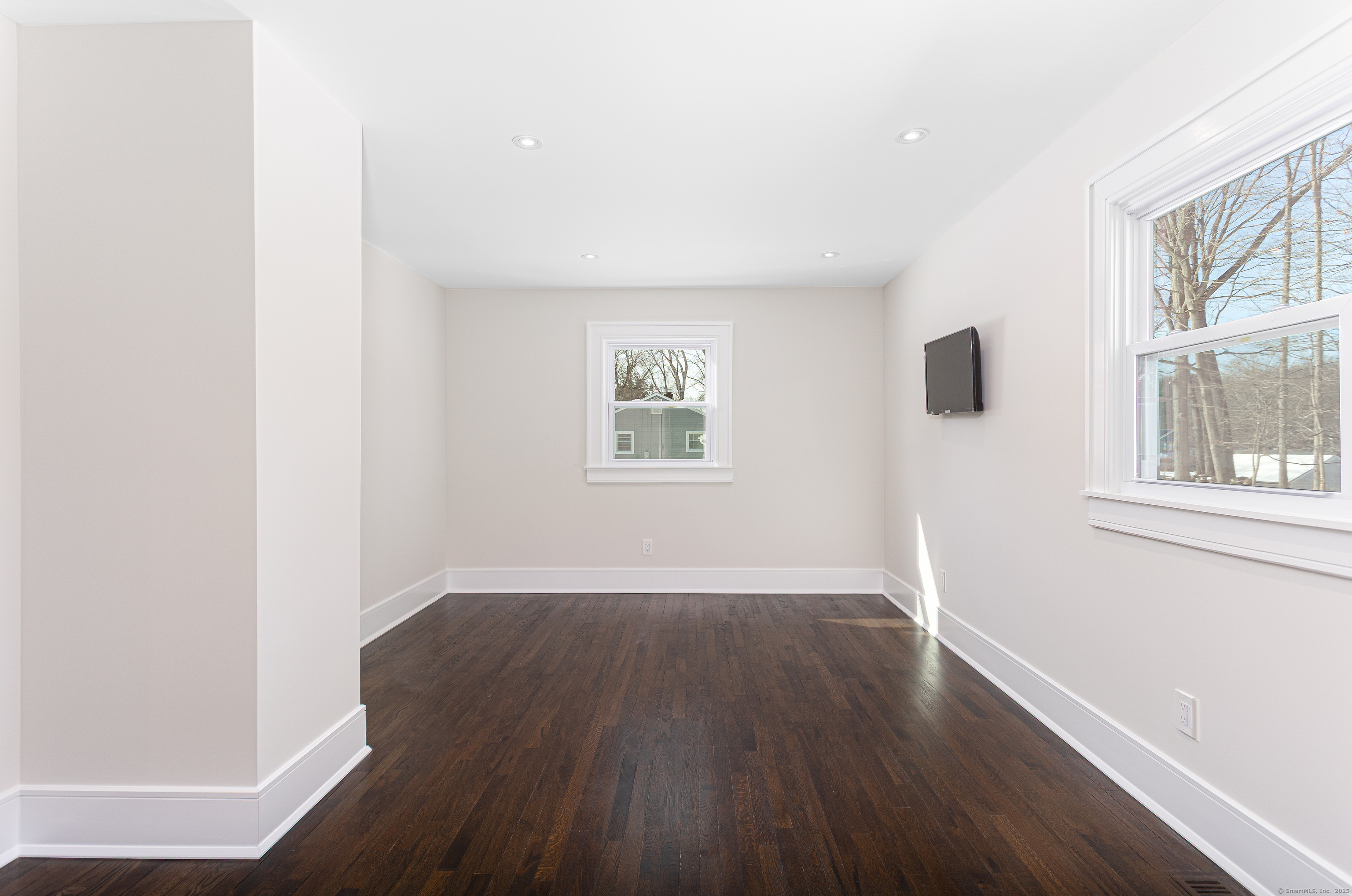 2750 Whitney Avenue Hamden, CT 06518 - Photo 4 of 13 an empty room with wooden floor and windows