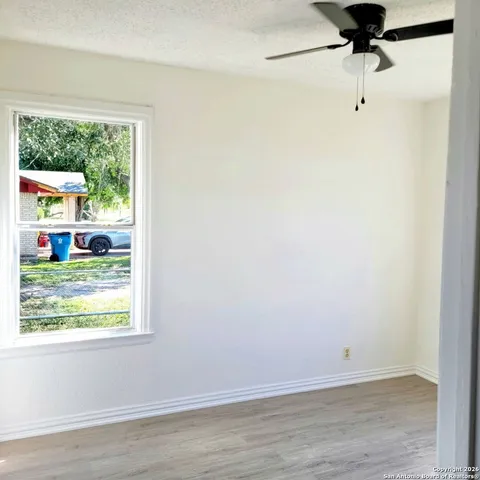 a room with a window and a ceiling fan