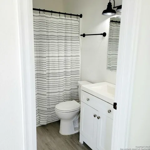 a bathroom with a toilet and a shower