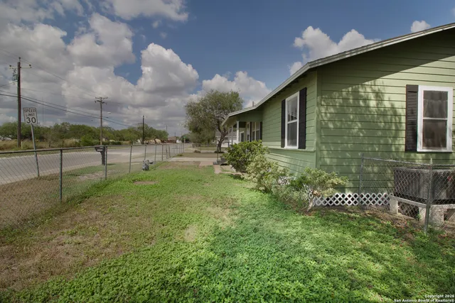 a backyard of a house with table and chairs