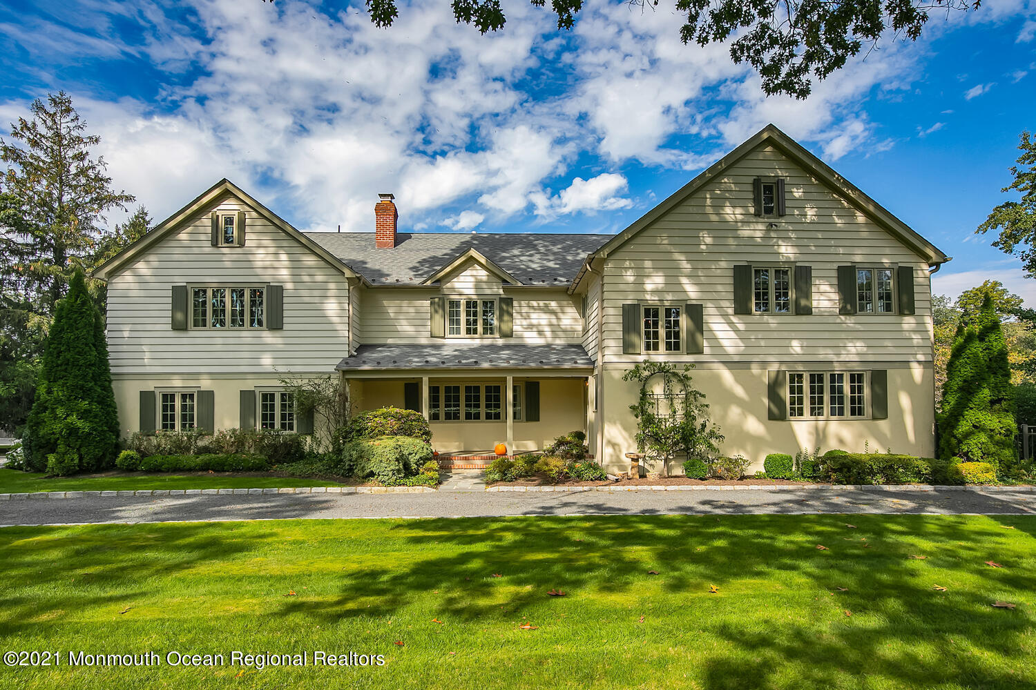 162 Black Point Road Rumson, NJ 07760 - Photo 2 of 58 a front view of a house with a yard table and chairs