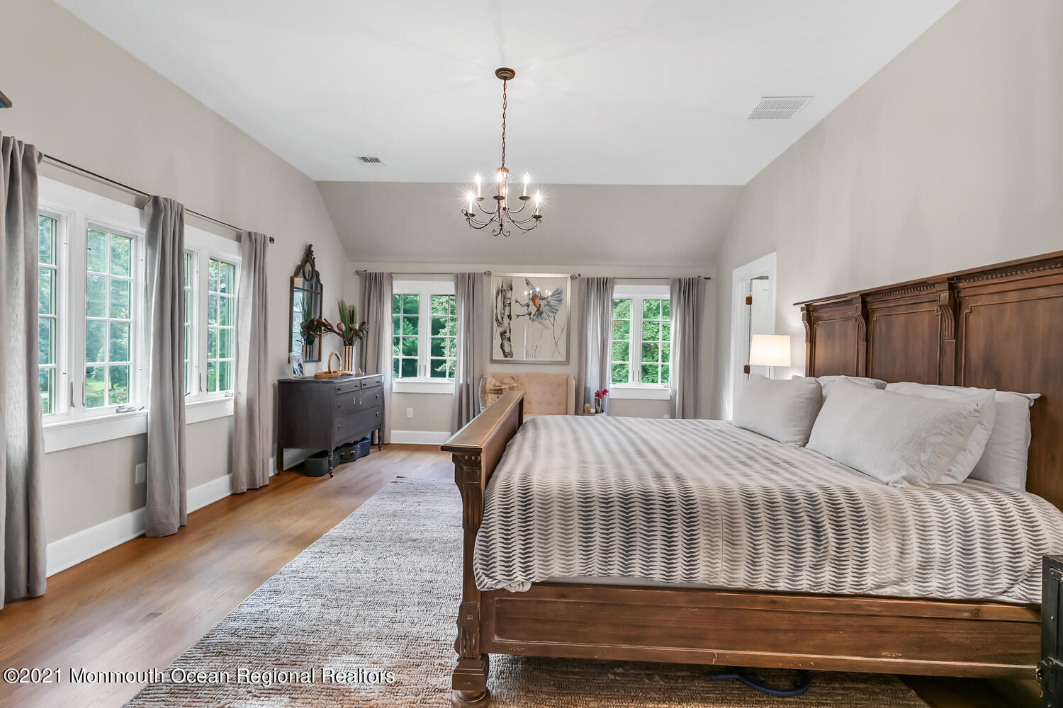 162 Black Point Road Rumson, NJ 07760 - Photo 26 of 58 a bedroom with a large bed and a chandelier
