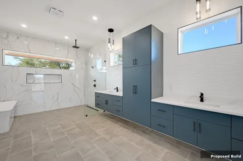 a view of a kitchen with white cabinets