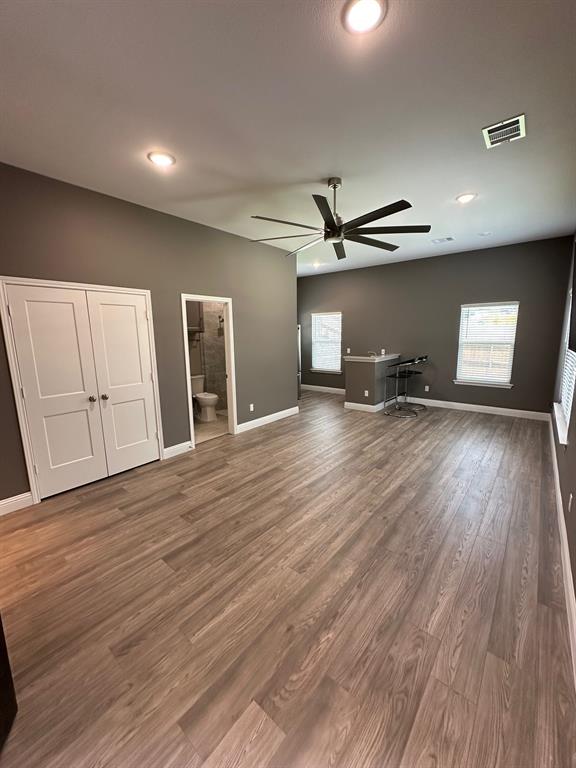 8912 Holt Street Lakeside, TX 76135 - Photo 15 of 39 a view of a livingroom with wooden floor and a ceiling fan