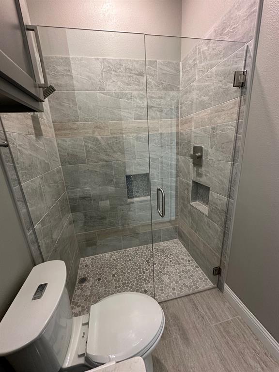 8912 Holt Street Lakeside, TX 76135 - Photo 20 of 39 a bathroom with a toilet and a shower