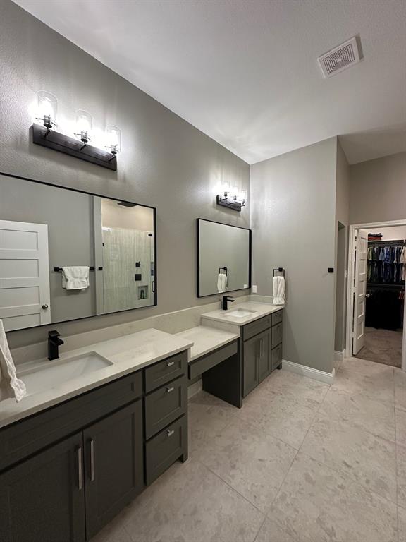 8912 Holt Street Lakeside, TX 76135 - Photo 23 of 39 a large bathroom with a sink a large mirror and a shower