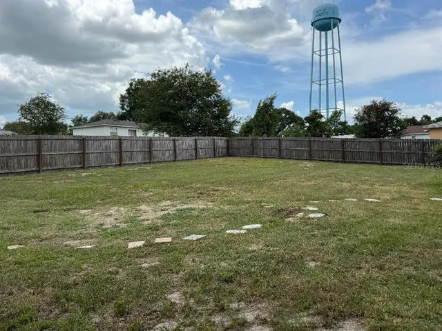 a view of a with a big yard and a fountain