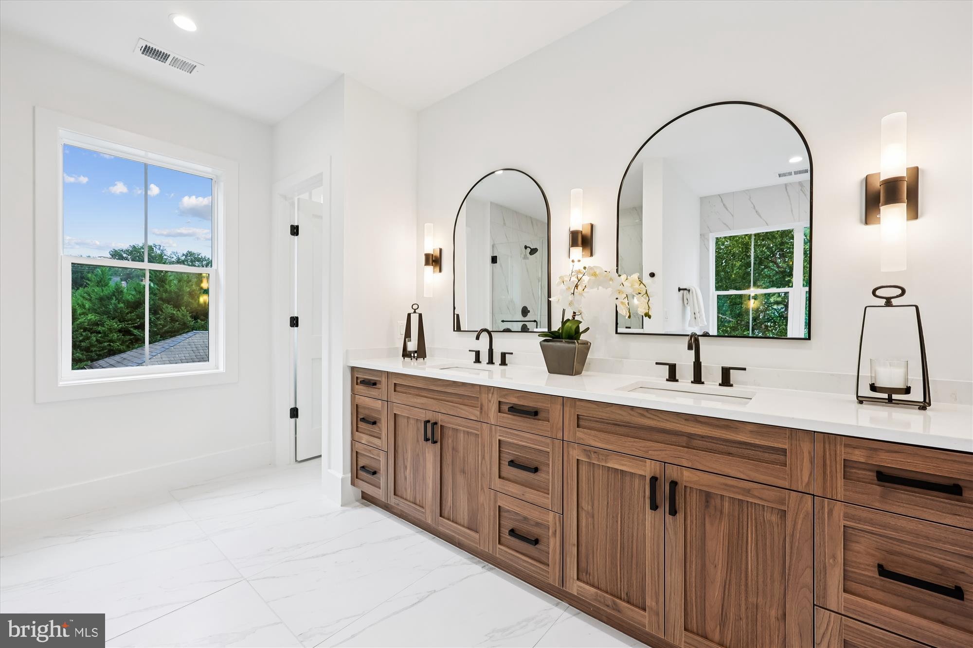 5605 Glenwood Road Bethesda, MD 20817 - Photo 30 of 57 a spacious bathroom with a double vanity sink a mirror and a window