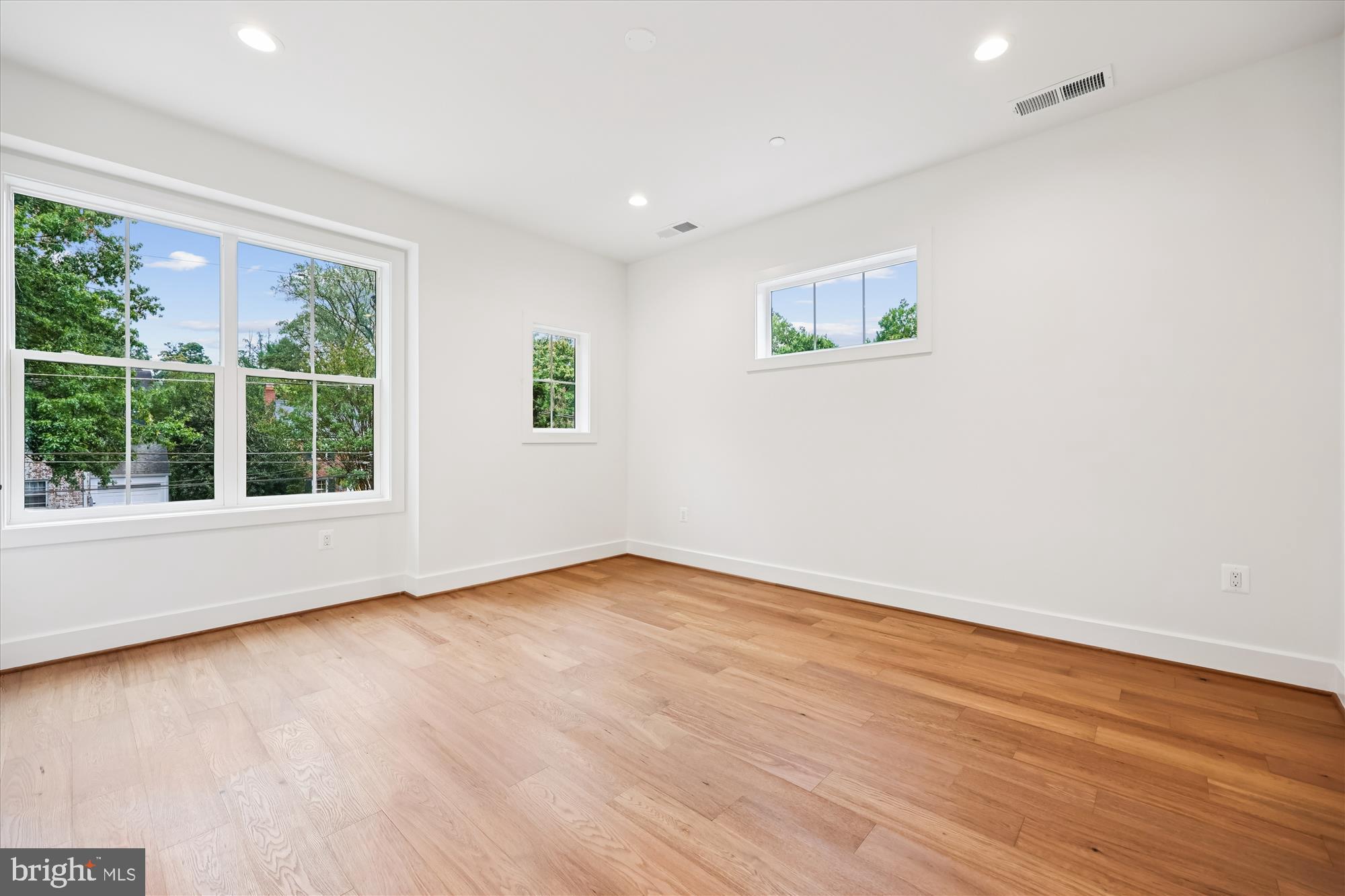 5605 Glenwood Road Bethesda, MD 20817 - Photo 34 of 57 an empty room with wooden floor and windows