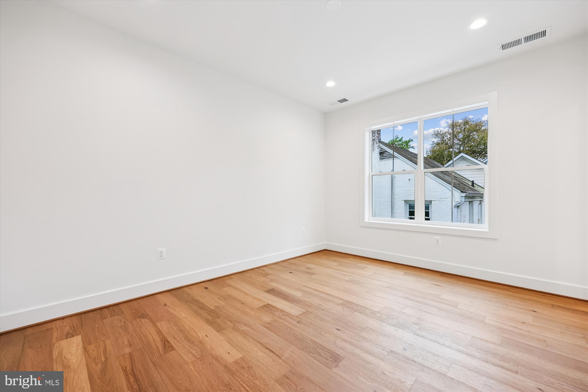 5605 Glenwood Road Bethesda, MD 20817 - Photo 35 of 57 a view of an empty room with wooden floor and a window