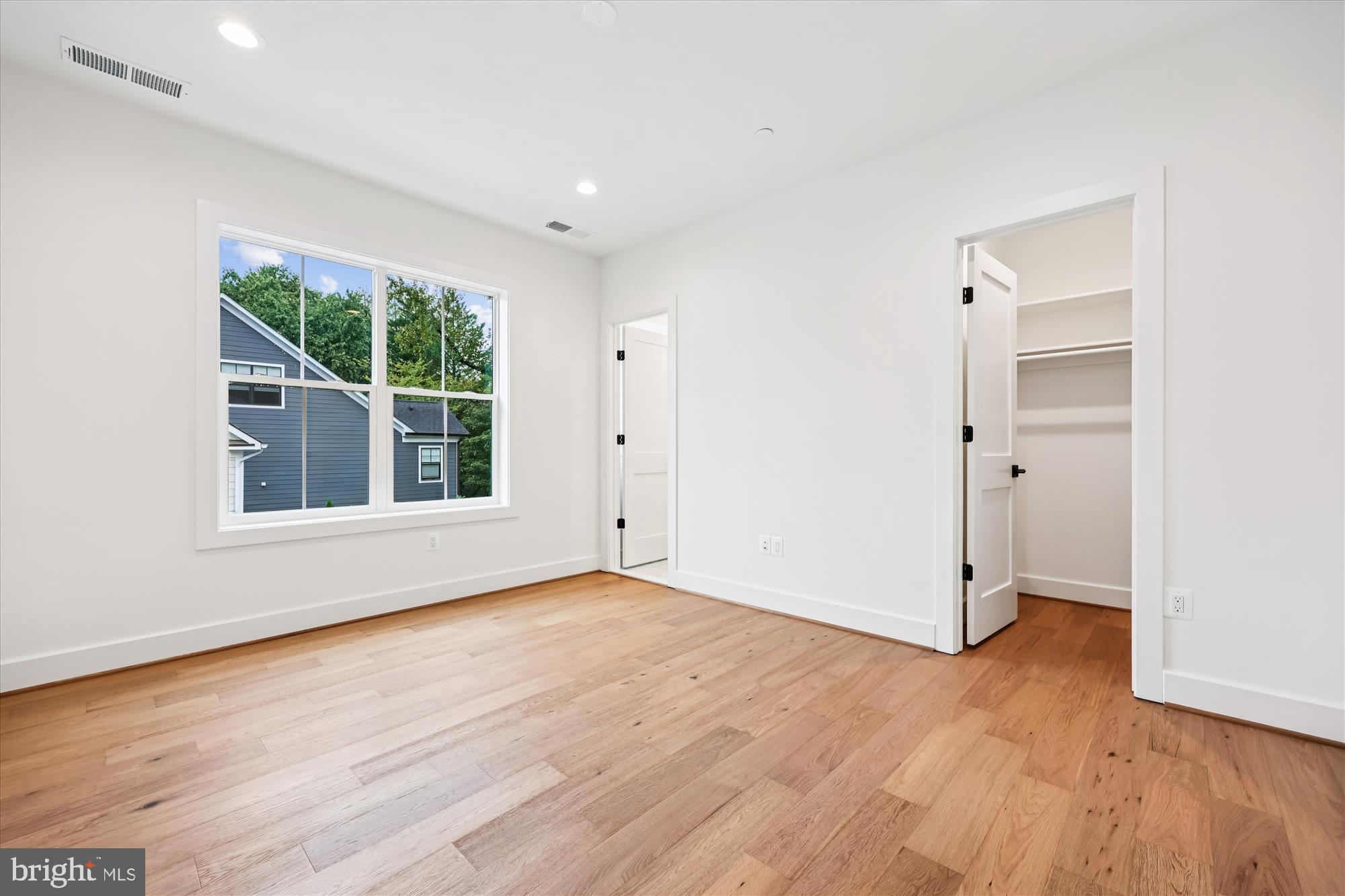 5605 Glenwood Road Bethesda, MD 20817 - Photo 39 of 57 an empty room with wooden floor and windows