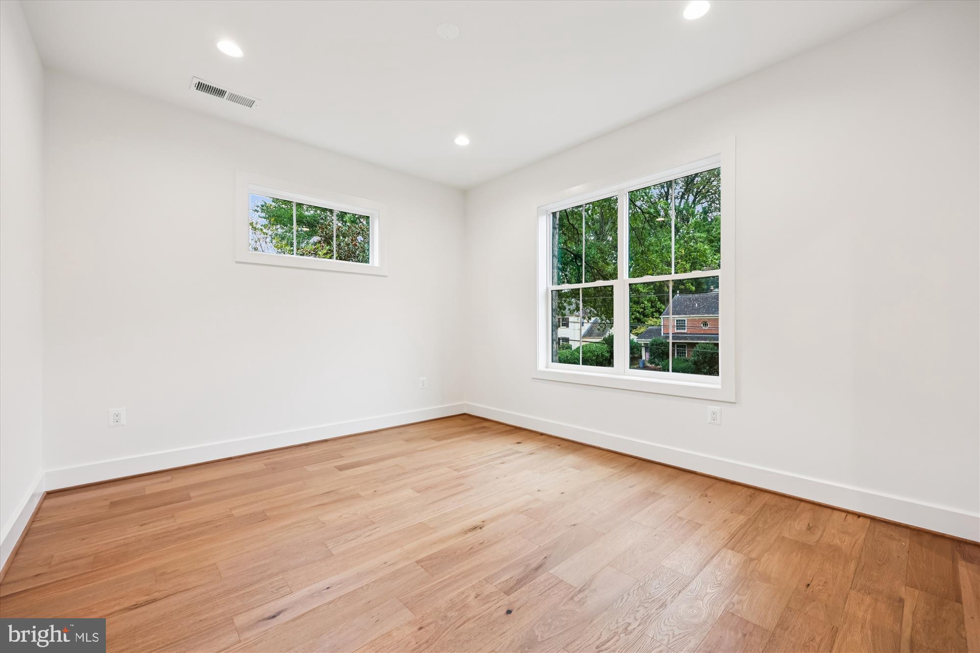 5605 Glenwood Road Bethesda, MD 20817 - Photo 41 of 57 an empty room with wooden floor and windows