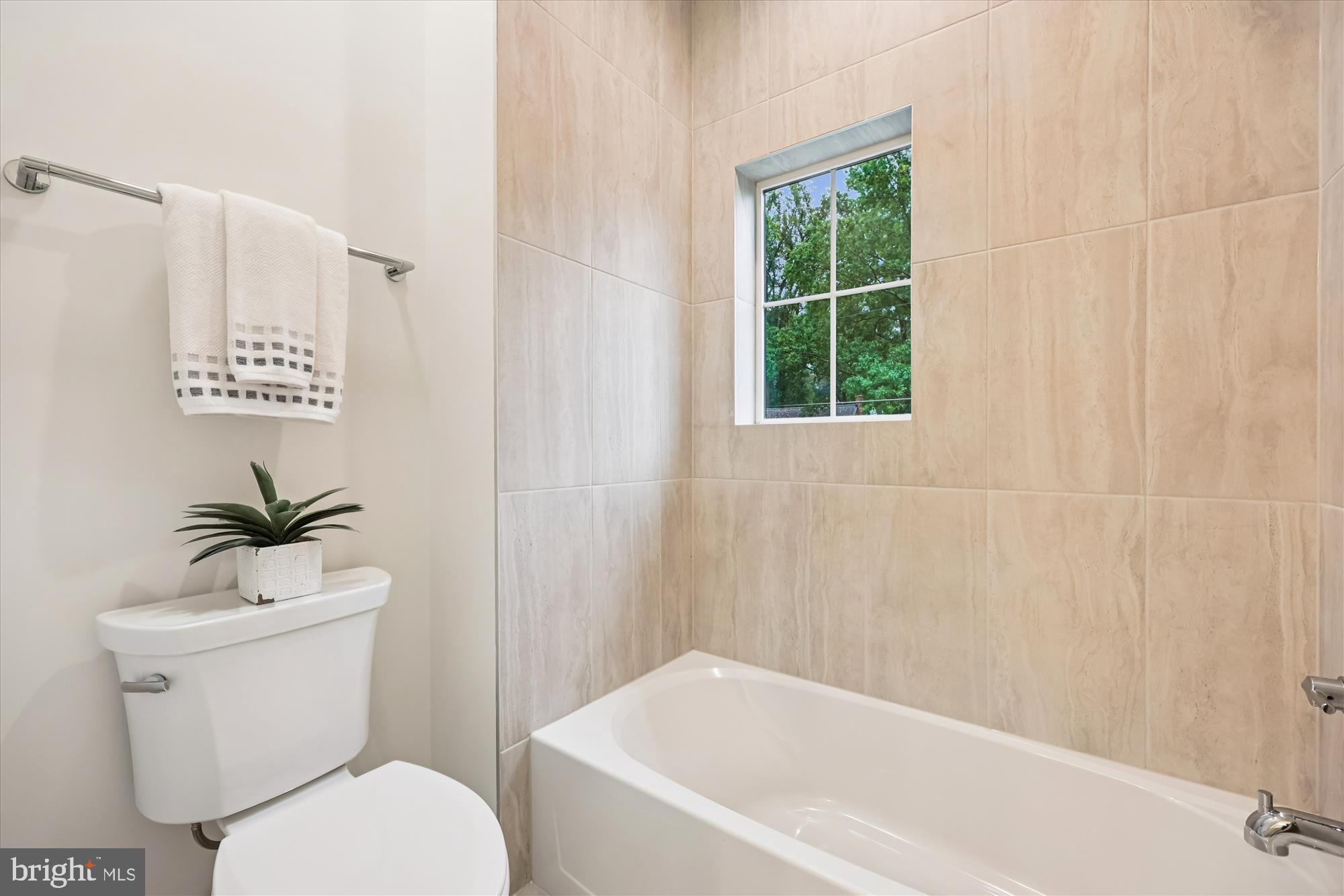 5605 Glenwood Road Bethesda, MD 20817 - Photo 43 of 57 a white toilet sitting next to a bath tub
