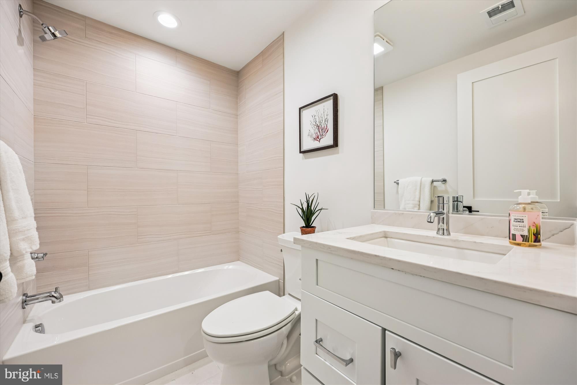 5605 Glenwood Road Bethesda, MD 20817 - Photo 47 of 57 a bathroom with a sink a toilet and shower