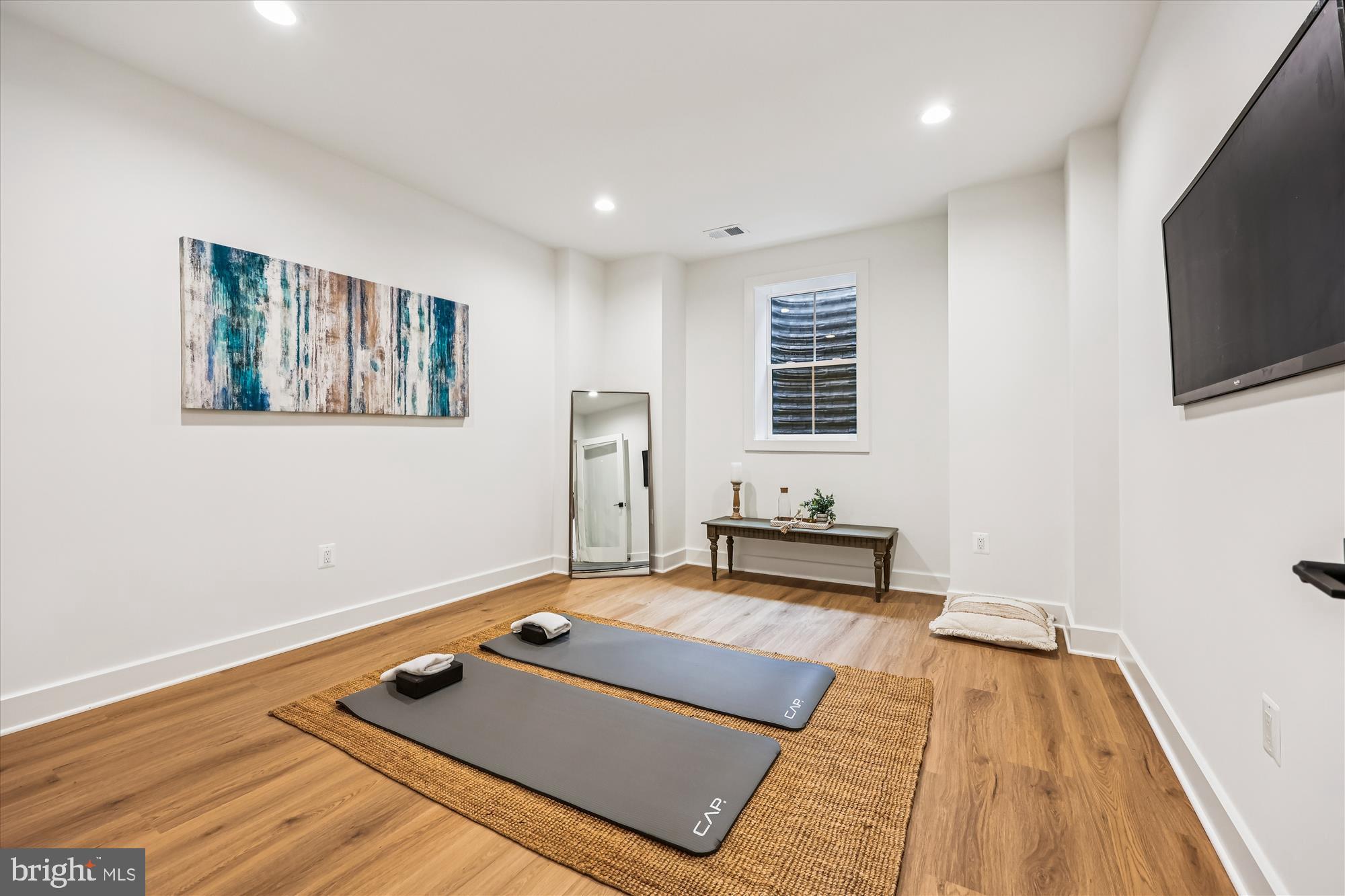 5605 Glenwood Road Bethesda, MD 20817 - Photo 51 of 57 a living room with hard wood floor and a flat screen tv