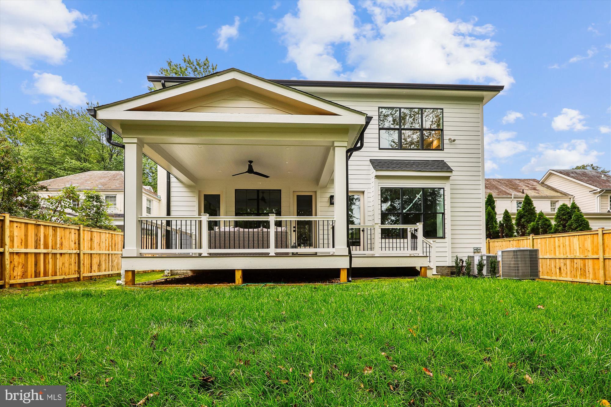 5605 Glenwood Road Bethesda, MD 20817 - Photo 54 of 57 a front view of a house with a yard table and chairs