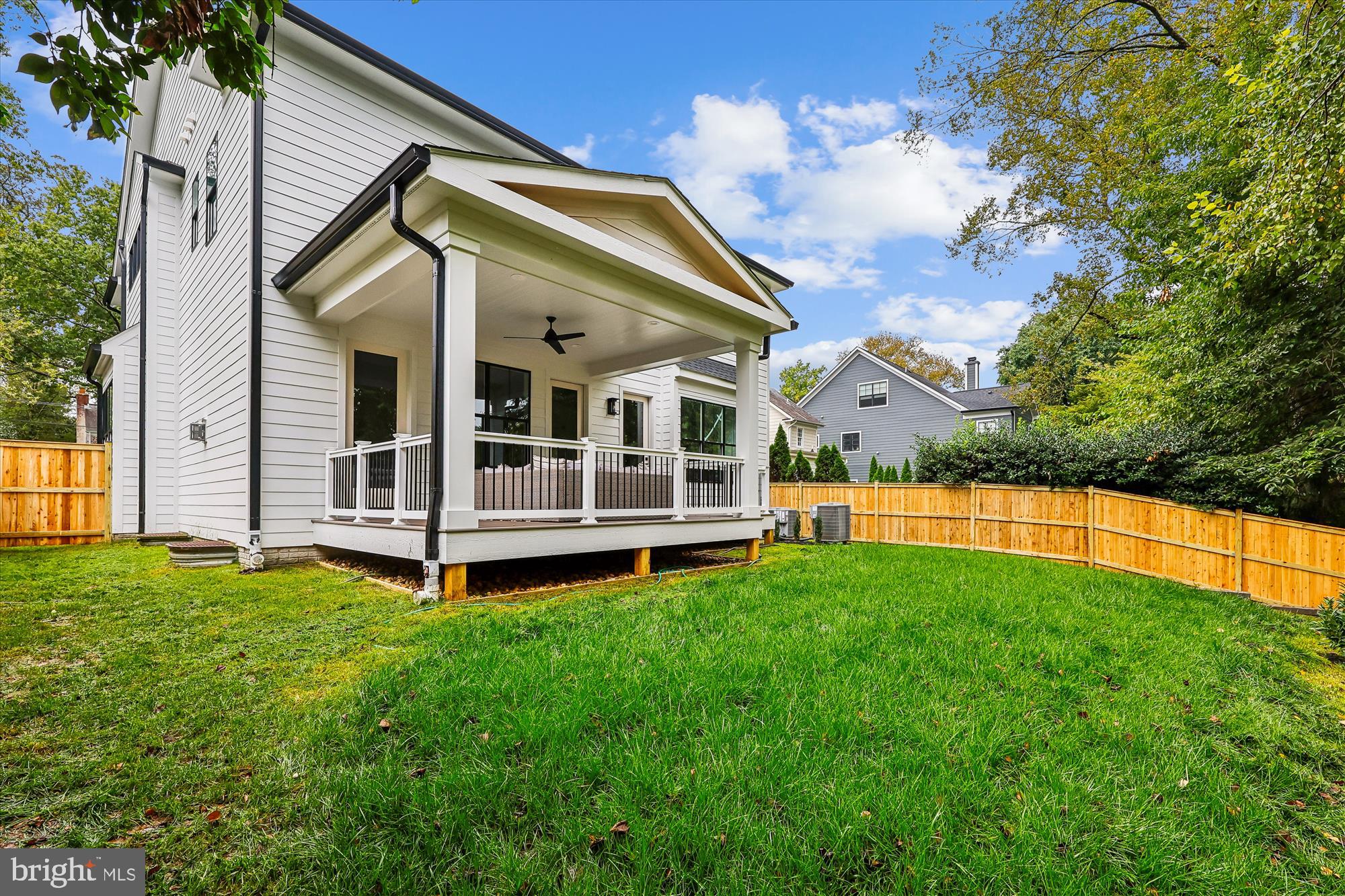 5605 Glenwood Road Bethesda, MD 20817 - Photo 55 of 57 a view of a house with a big yard potted plants and large tree