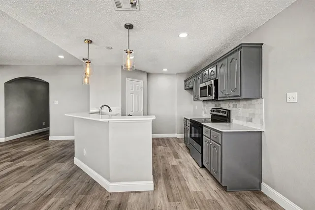 a view of kitchen with sink microwave and stove
