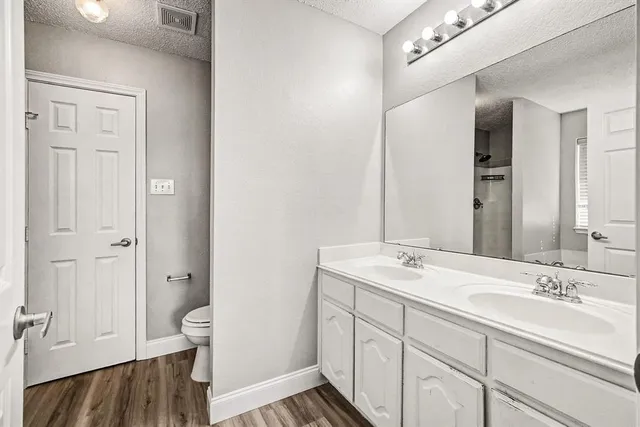 a spacious bathroom with a sink and a mirror