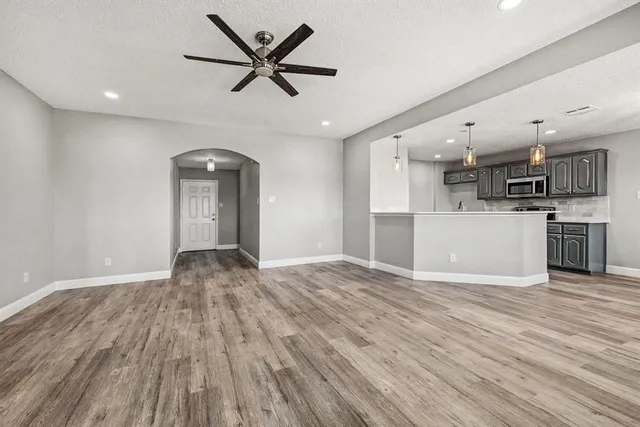a view of a kitchen with a sink and wooden floor