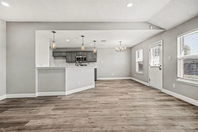 a view of a kitchen with a sink and a refrigerator