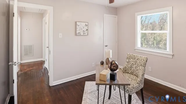 a view of a room with furniture and wooden floor