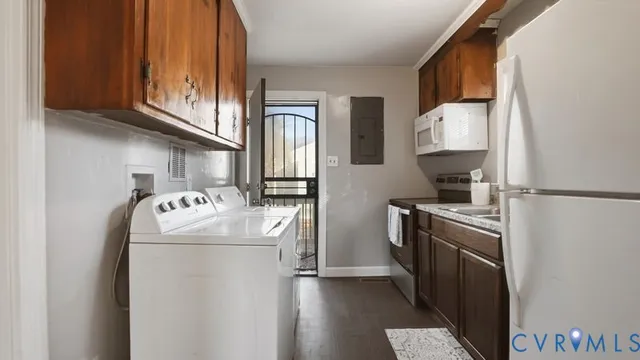 a kitchen with stainless steel appliances granite countertop a refrigerator a stove and a sink