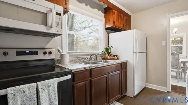 a kitchen with stainless steel appliances a refrigerator and a sink