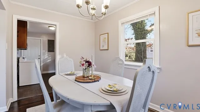 a view of a dining room with furniture a chandelier and wooden floor