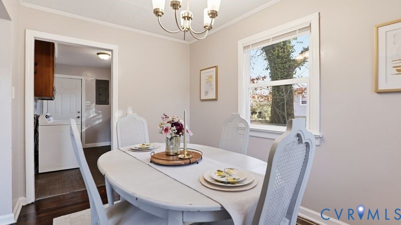2313 Ruffin Road Richmond, VA 23234 - Photo 31 of 40 a view of a dining room with furniture a chandelier and wooden floor
