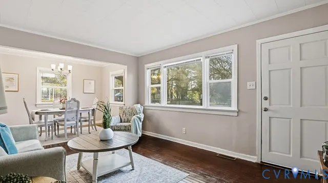 a dining room with furniture and wooden floor